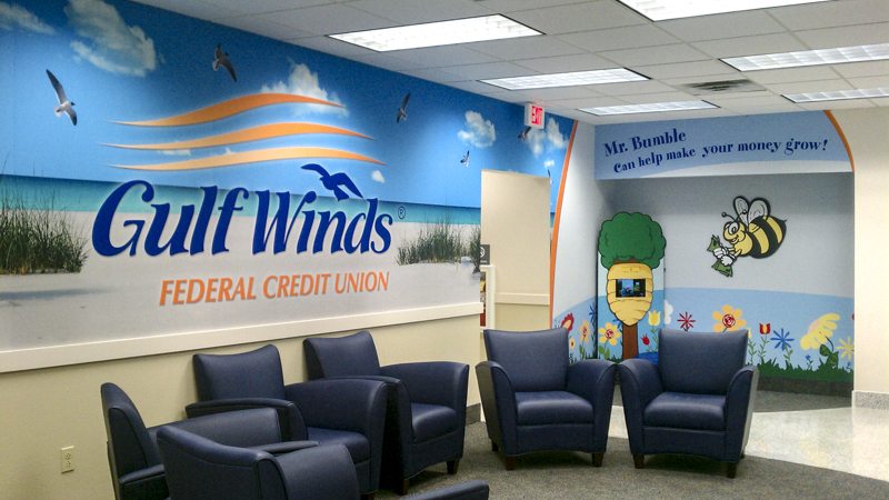 Branded wall wrap at Gulf Winds Federal Credit Union lobby - signgeek branded interiors 
