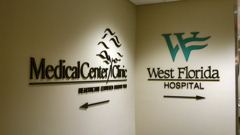 Interior directional wayfinding signage at Medical Center Clinic and West Florida Hospital - Signgeek branded interiors and dimensional signage