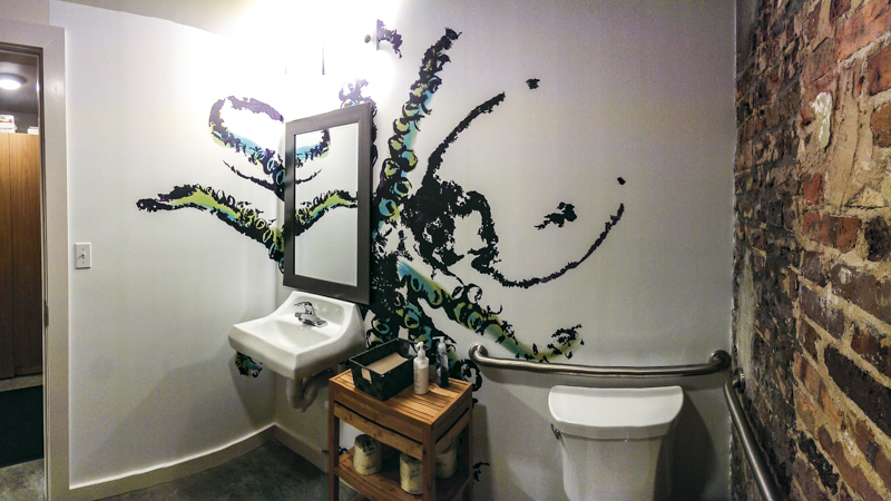 Restroom interior octopus gyotaku wall wrap at Nom Sushi - Signgeek Environmental Graphics