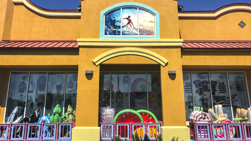 Display window graphics of a surfer at Waves on Pensacola Beach - Signgeek Environmental Graphics 
