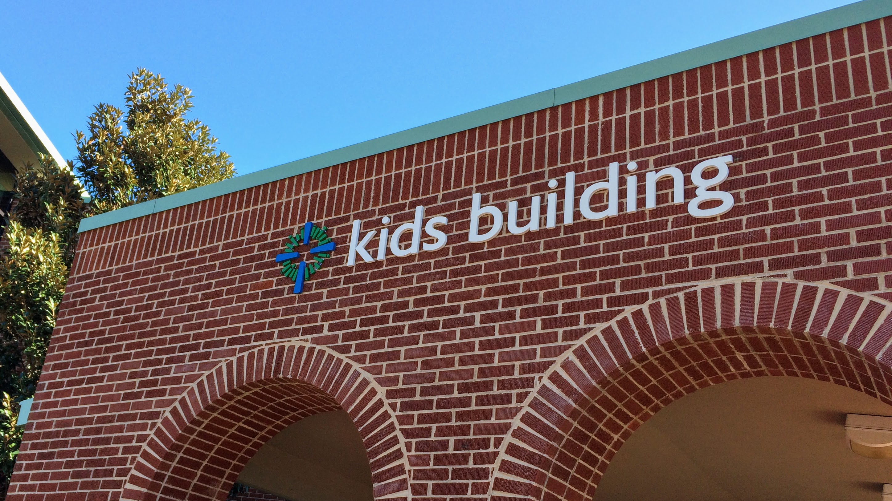 Exterior wayfinding for kids building on church campus with dimensional letters - signgeek Wayfinding 